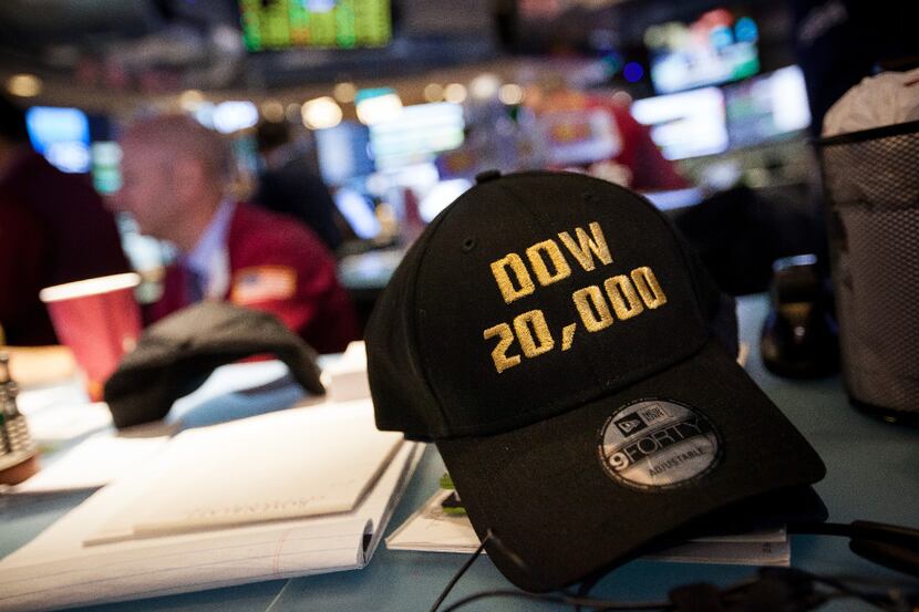 A "DOW 20,0000" hat sits on a desk on the floor of the New York Stock Exchange (NYSE) in New...