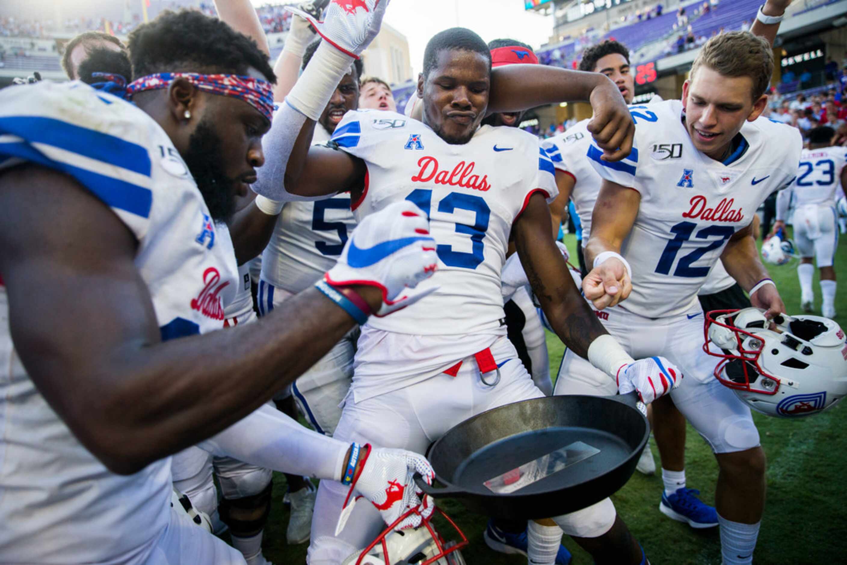 Southern Methodist Mustangs celebrate a 41-38 win over TCU Horned Frogs by hoisting the...