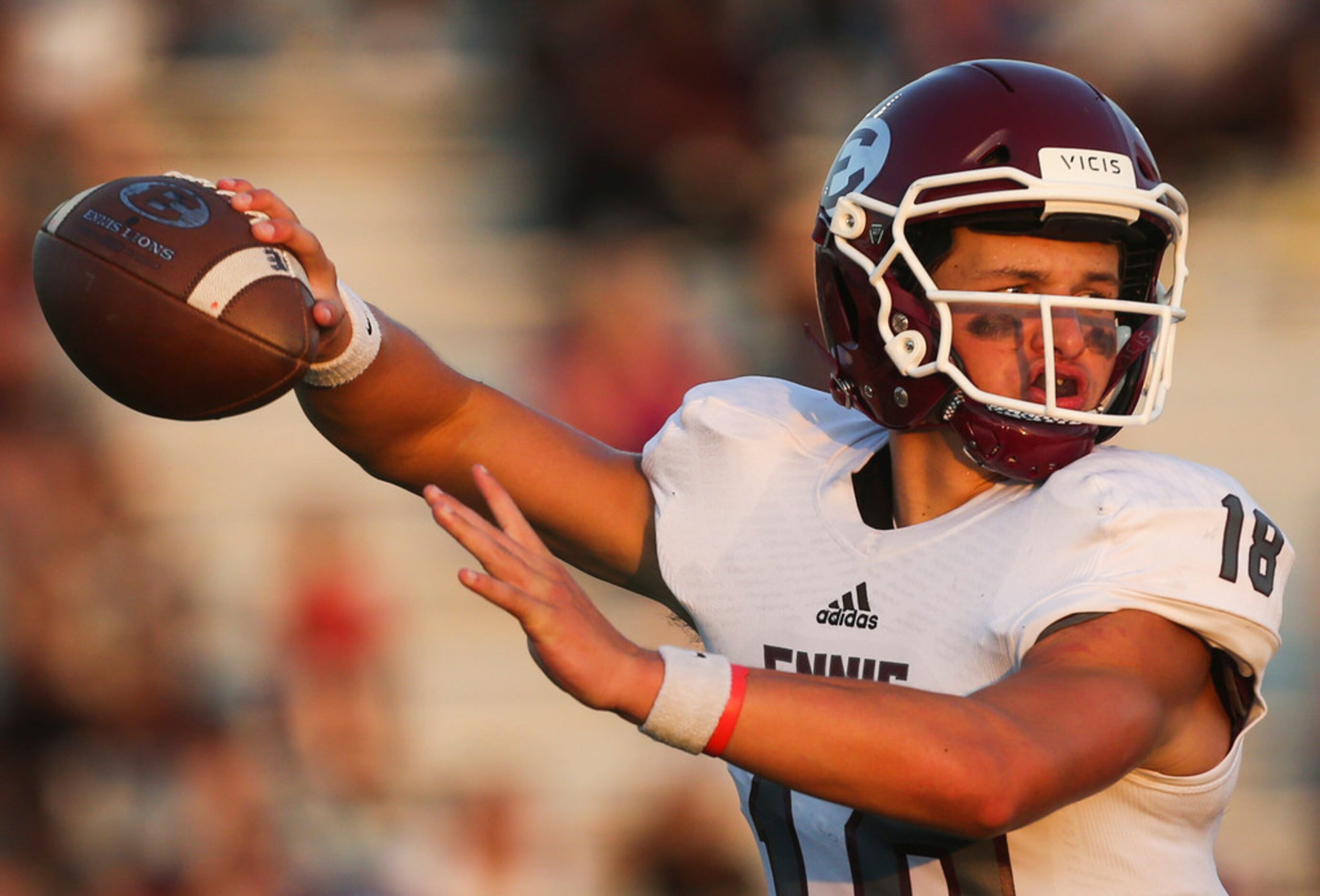 Ennis quarterback Collin Drake (18) fires off a pass during a high school football game...