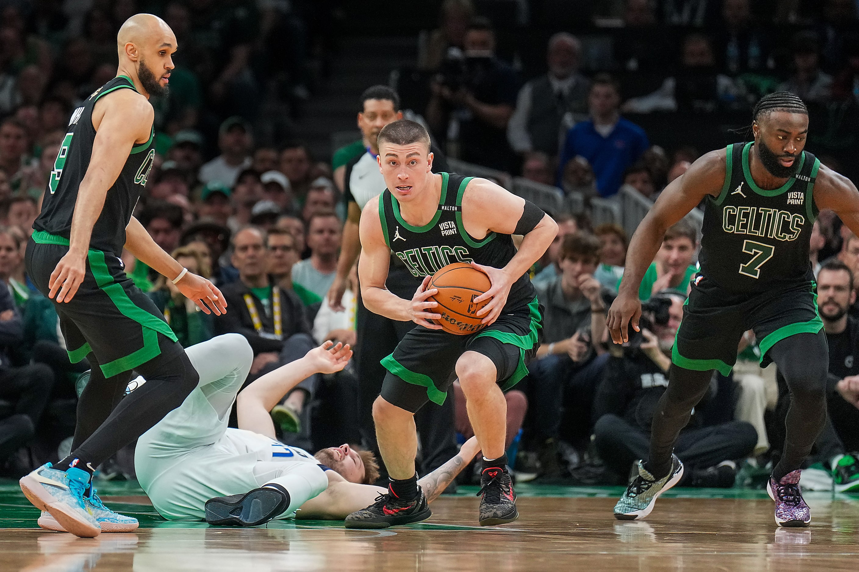 Dallas Mavericks guard Luka Doncic hits the floor as Boston Celtics guard Payton Pritchard...