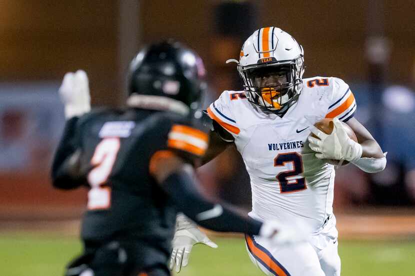 Wakeland junior running back Jared White, right, looks for room against Lancaster senior...