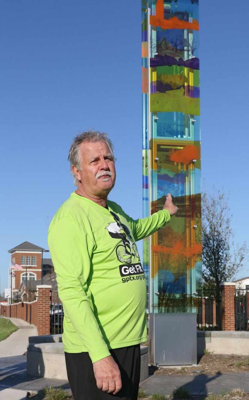 
Grand Prairie Mayor Ron Jensen points at the Colorful History art installation during his...