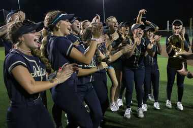 Keller players are elated at the presentation of the Class 6A Region l semifinal trophy...