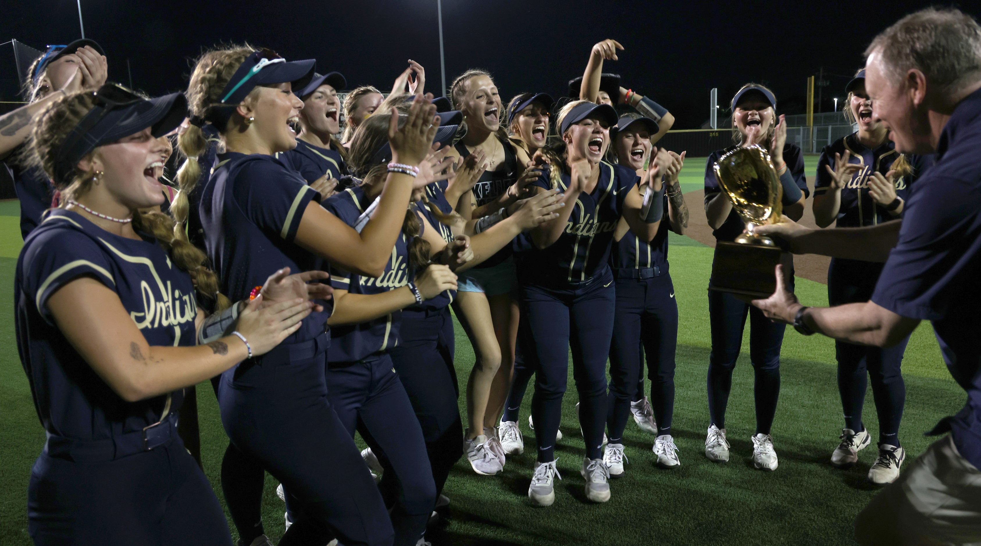 Keller players are elated at the presentation of the Class 6A Region l semifinal trophy...