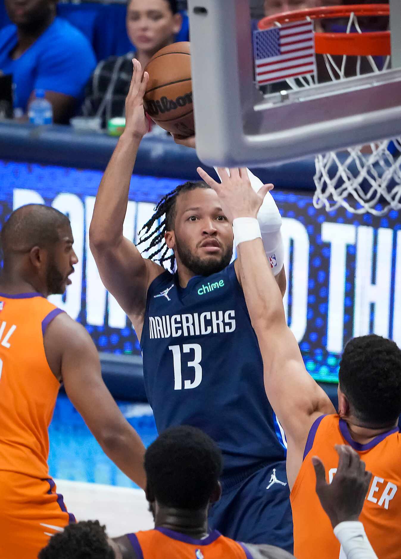 Dallas Mavericks guard Jalen Brunson (13) shoots over Phoenix Suns guard Devin Booker (1)...