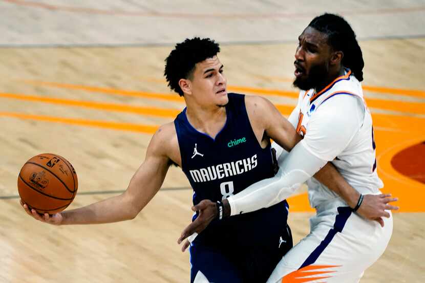 Suns forward Jae Crowder defends Mavericks guard Josh Green during the first half of a game...