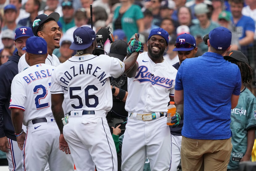 American League's Adolis Garcia, of the Texas Rangers, greets Randy Arozarena, of the Tampa...