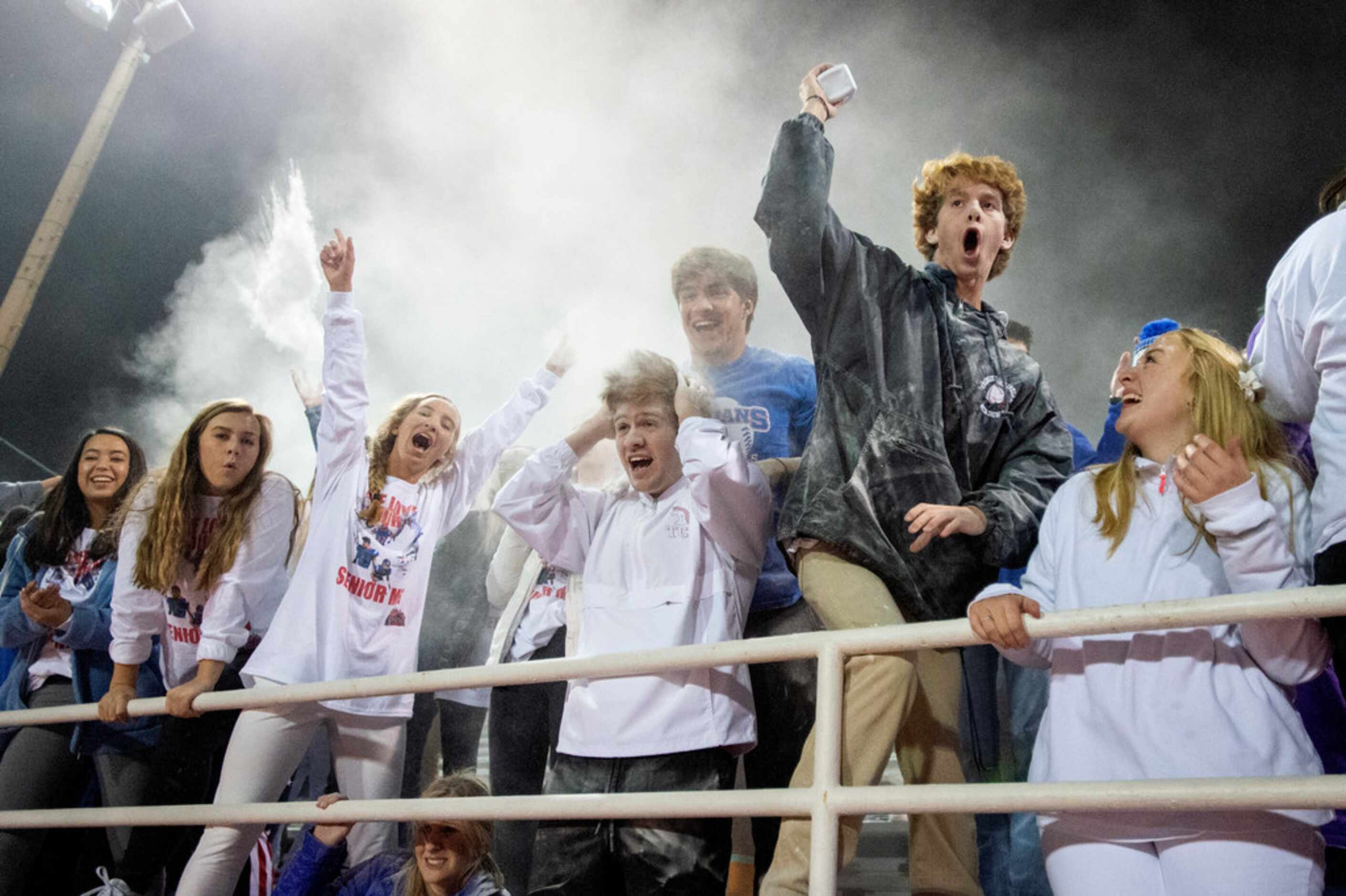 TCA-Addison students toss baby powder in the air during the second half of a high school...