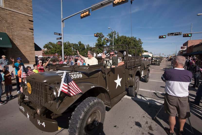 
Vintage military vehicles parade through Garland, which was bypassed by the convoy in 1920....