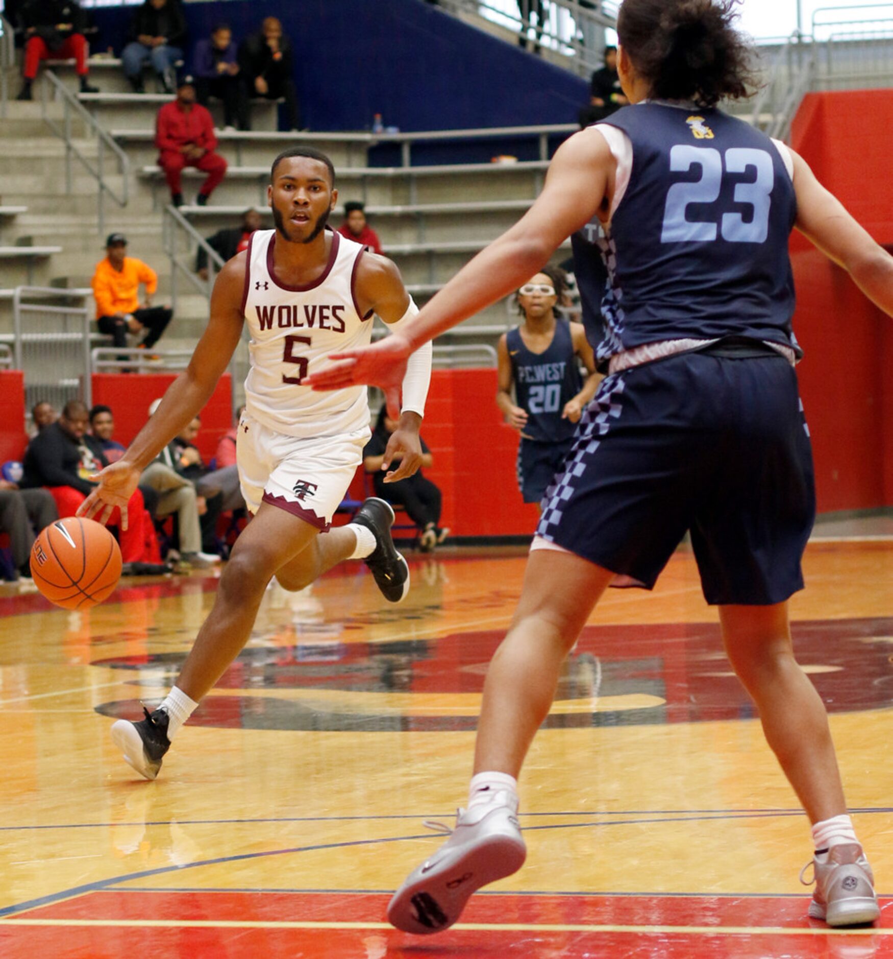 Mansfield Timberview sophomore Jared Washington (5) brings the ball past midcourt as he is...