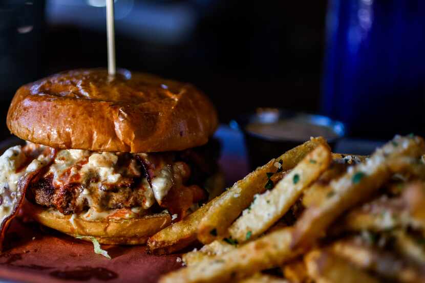 The Kermit burger has blue cheese, bacon and Frank's Hot Sauce on a beef patty. It's served...