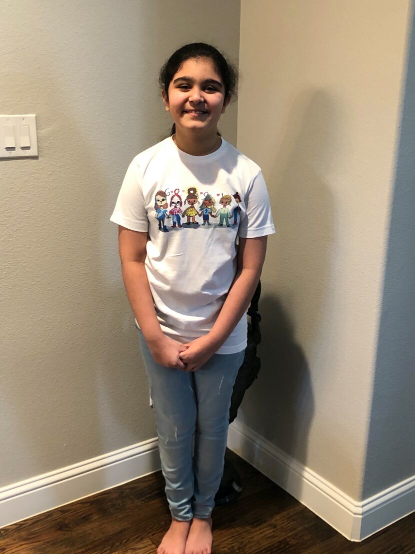 Frisco fifth-grader Sharon Sara wears a shirt featuring her doodle, which will be seen on...