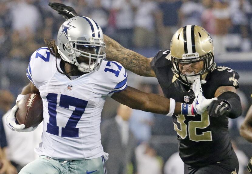 Dallas Cowboys wide receiver Dwayne Harris (17) stiff arms New Orleans Saints strong safety...
