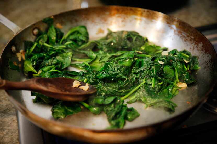 Julian Barsotti sautes spinach with garlic, to be layered into his 21-layer timpano.