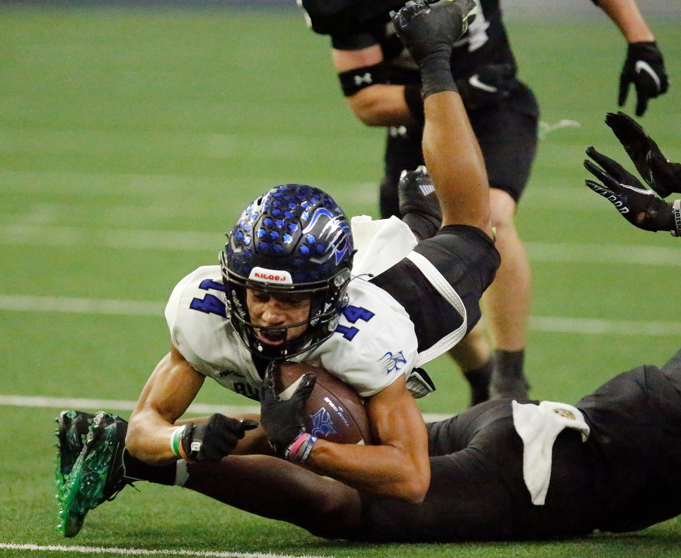 Byron Nelson High School wide receiver Landon Ransom-Golez (14) lunges for extra yardage...