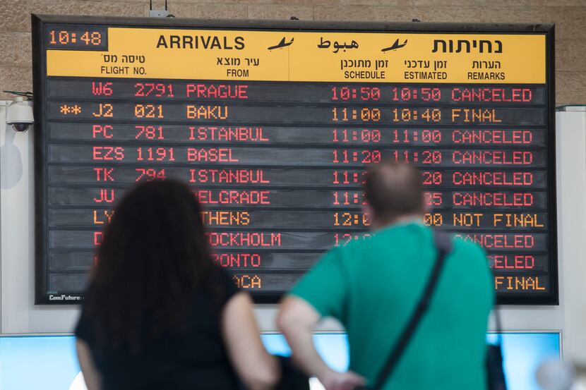 A arrivals flight board displays various canceled and delayed flights in Ben Gurion...