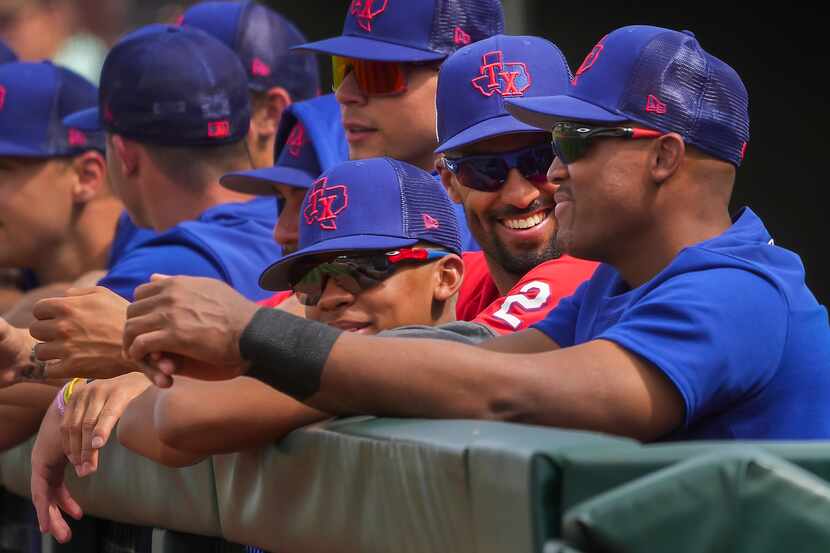 Texas Rangers infielder Marcus Semien (2) laughs with former Rangers third baseman Adrian...