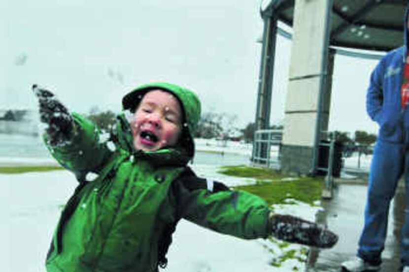  Zachary Hammett of Arlington enjoys the snow at Bethany Lakes Park in Allen. His family...