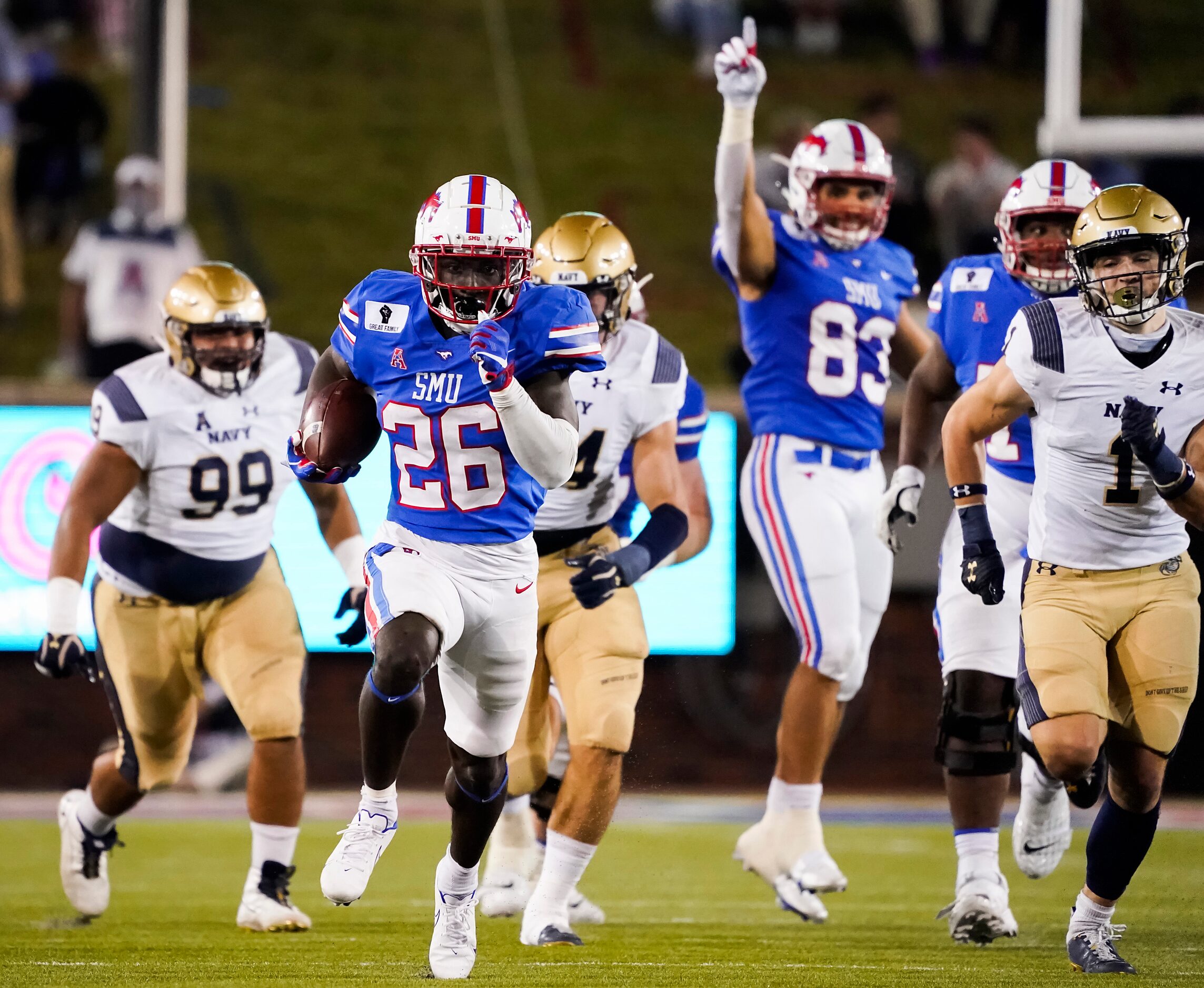 SMU running back Ulysses Bentley IV (26) gets past Navy linebacker John Marshall (1) on a...