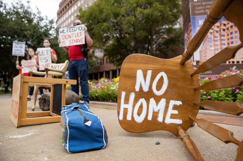 Protestors place furniture and rally outside of the office of Senator John Cornyn "to show...