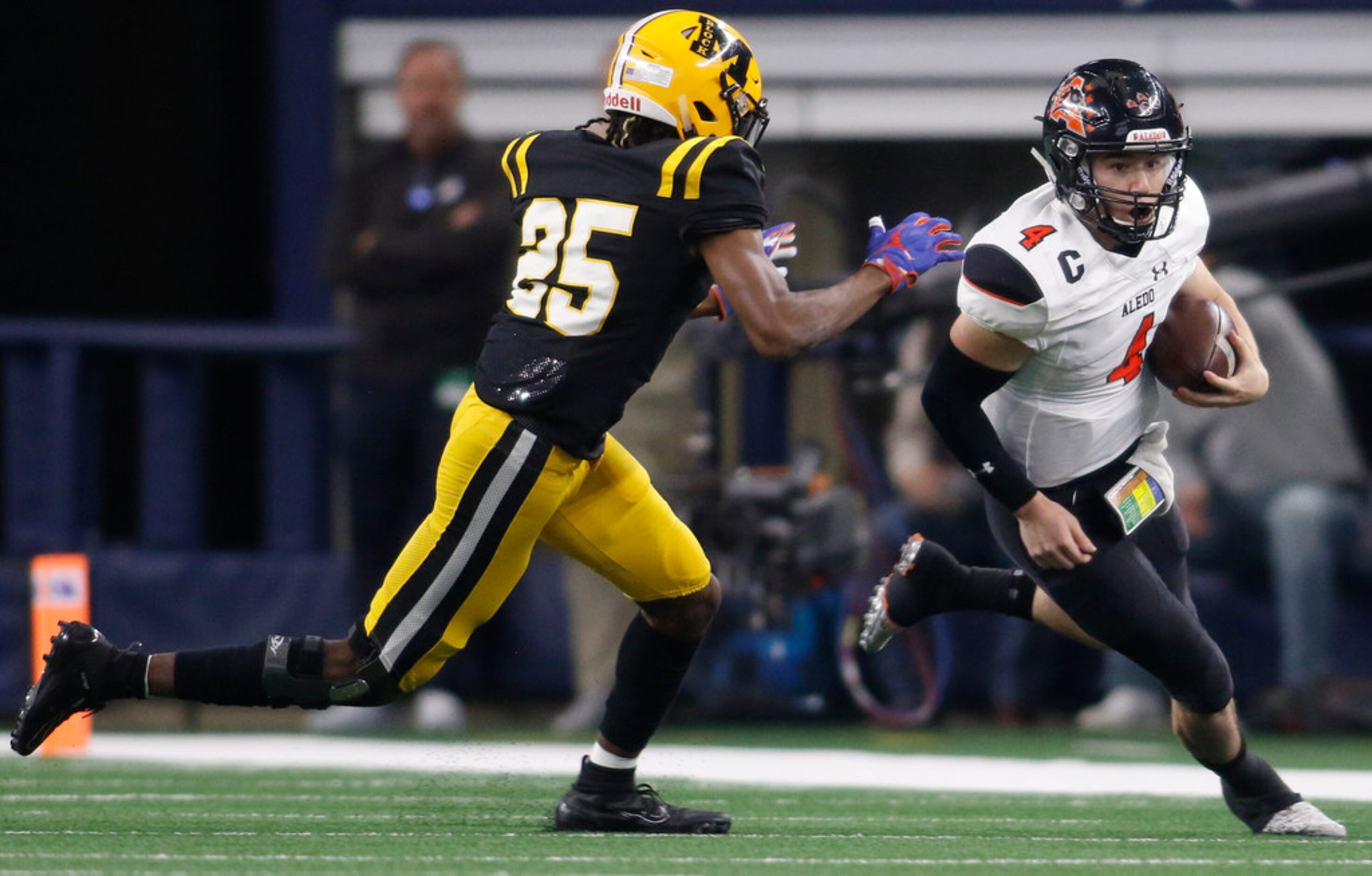 Aledo quarterback Jake Bishop (4) rushes for a first half first down as he is pursued...