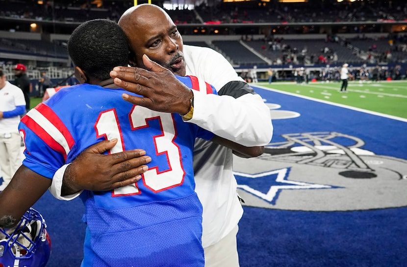 Duncanville head coach Reginald Samples hugs wide receiver Roderick Daniels (13) after the...