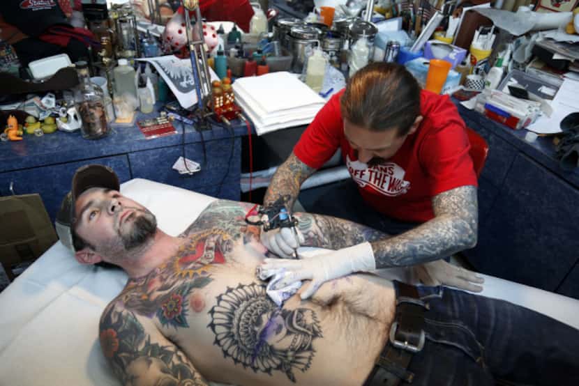 Oliver Peck, with Joe McAmis at his shop in Deep Ellum,  did 415 tattoos in 24 hours In June...
