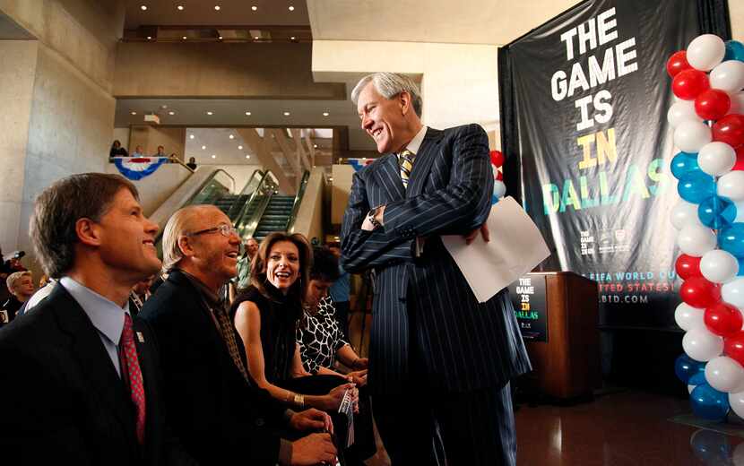 Dallas mayor Tom Leppert (standing) shares a laugh with Jim Graham, (second from left) and...