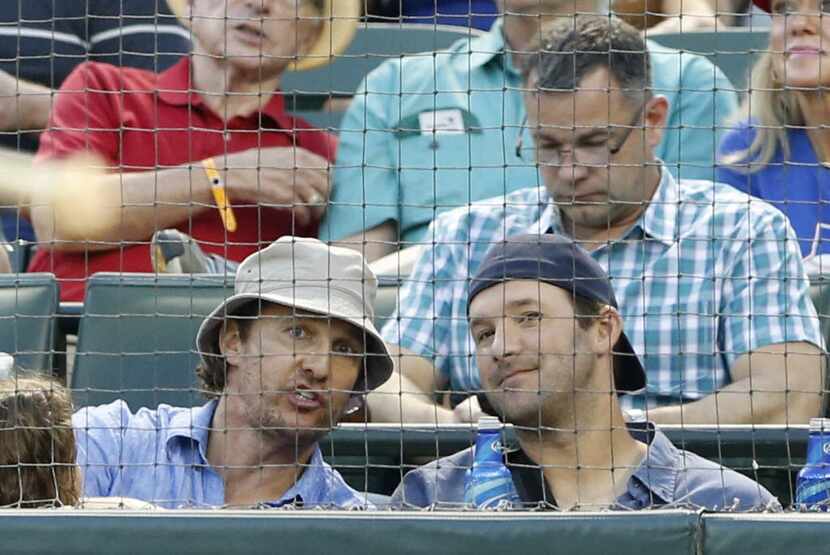 Actor Matthew McConaughey talks to Dallas Cowboys quarterback Tony Romo as Detroit Tigers...