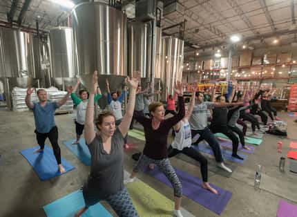 Yoga participants take part in a class at Community Beer Company on Saturday, Jan. 14, 2017.