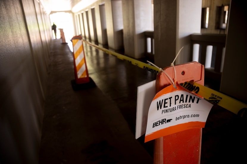 Newly applied paint was visible Monday on the floor of the pedestrian walkway that connects...