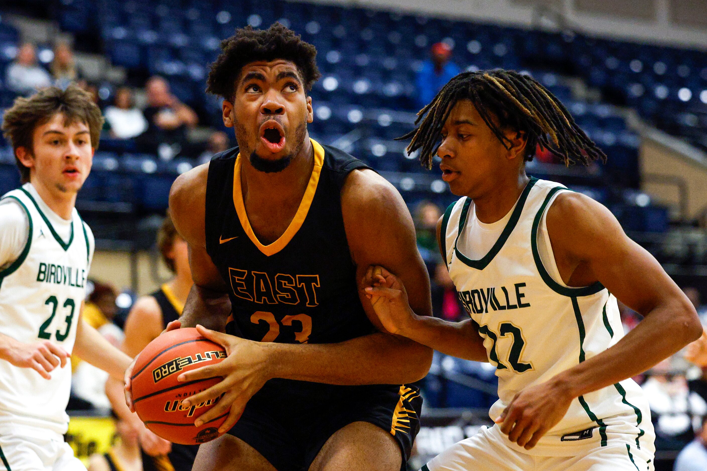 Plano East post Cameron Brown (23) drives past Birdville guard Kalil Coburn (22) during the...