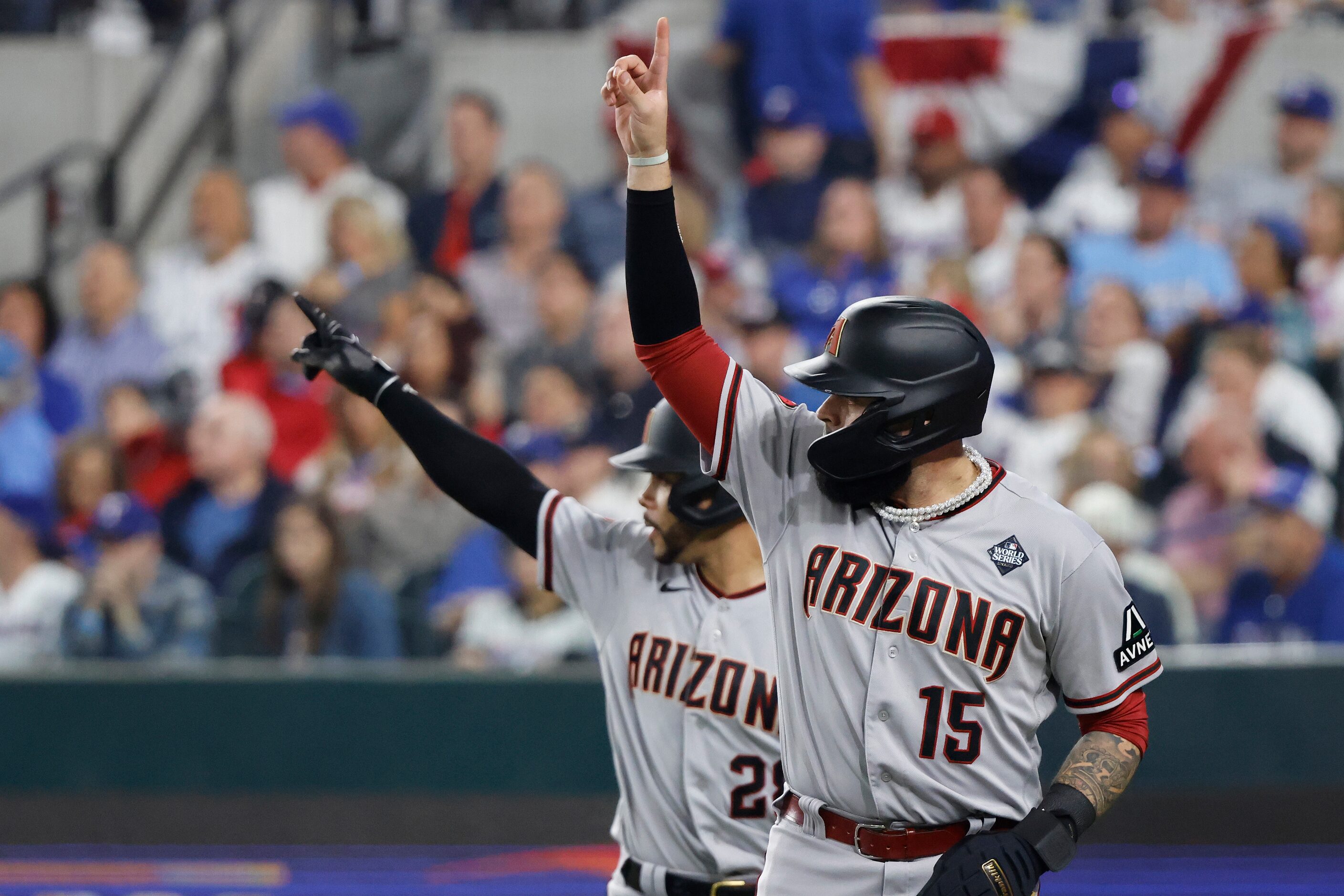 Arizona Diamondbacks' Emmanuel Rivera (15) and Tommy Pham celebrate after scoring on a...