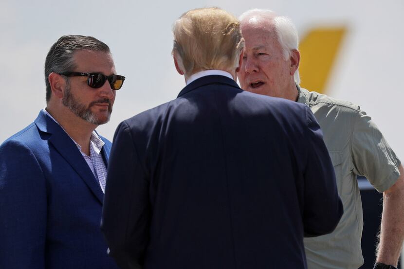 President Donald Trump talks with Sens. John Cornyn (right) and Ted Cruz as he arrives at El...