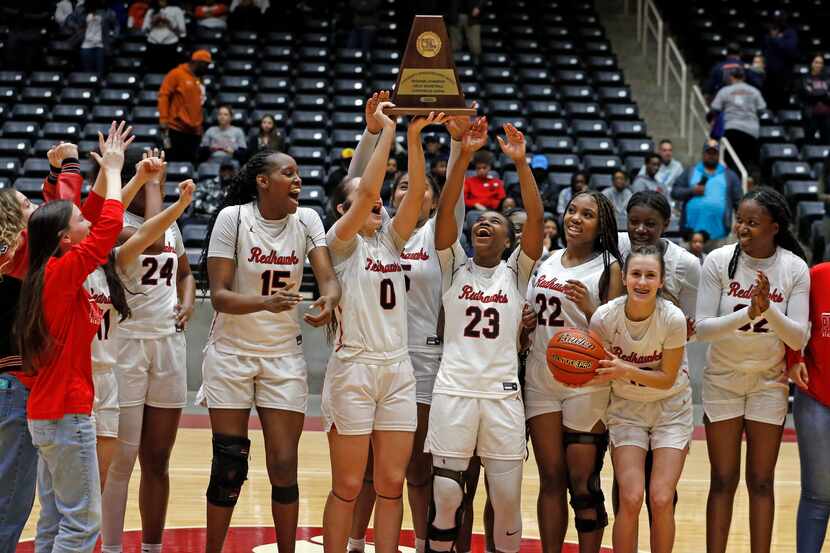 Frisco Liberty High’s G Jezelle Jolie Moreno (0) holds the championship trophy high, and she...