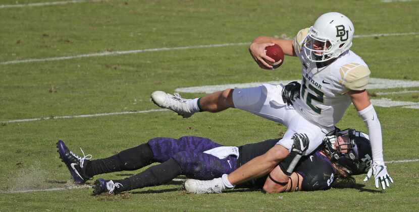 Baylor Bears quarterback Charlie Brewer (12) is sacked by TCU Horned Frogs defensive end Mat...