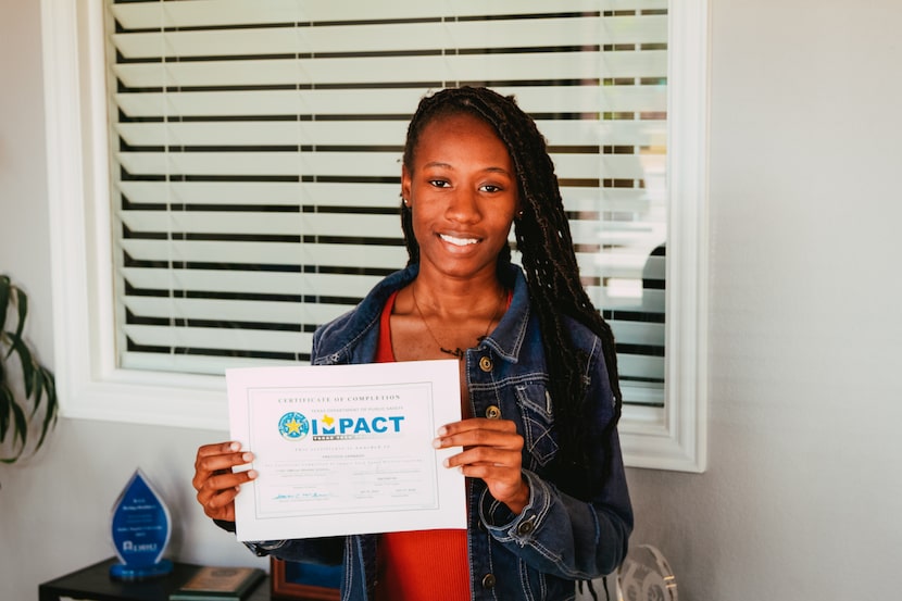 Young teen proudly holds up her driving certificate.