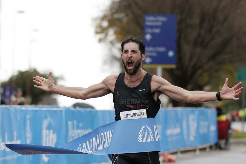 Logan Sherman crosses the finish line to win the 2015 Dallas Marathon.