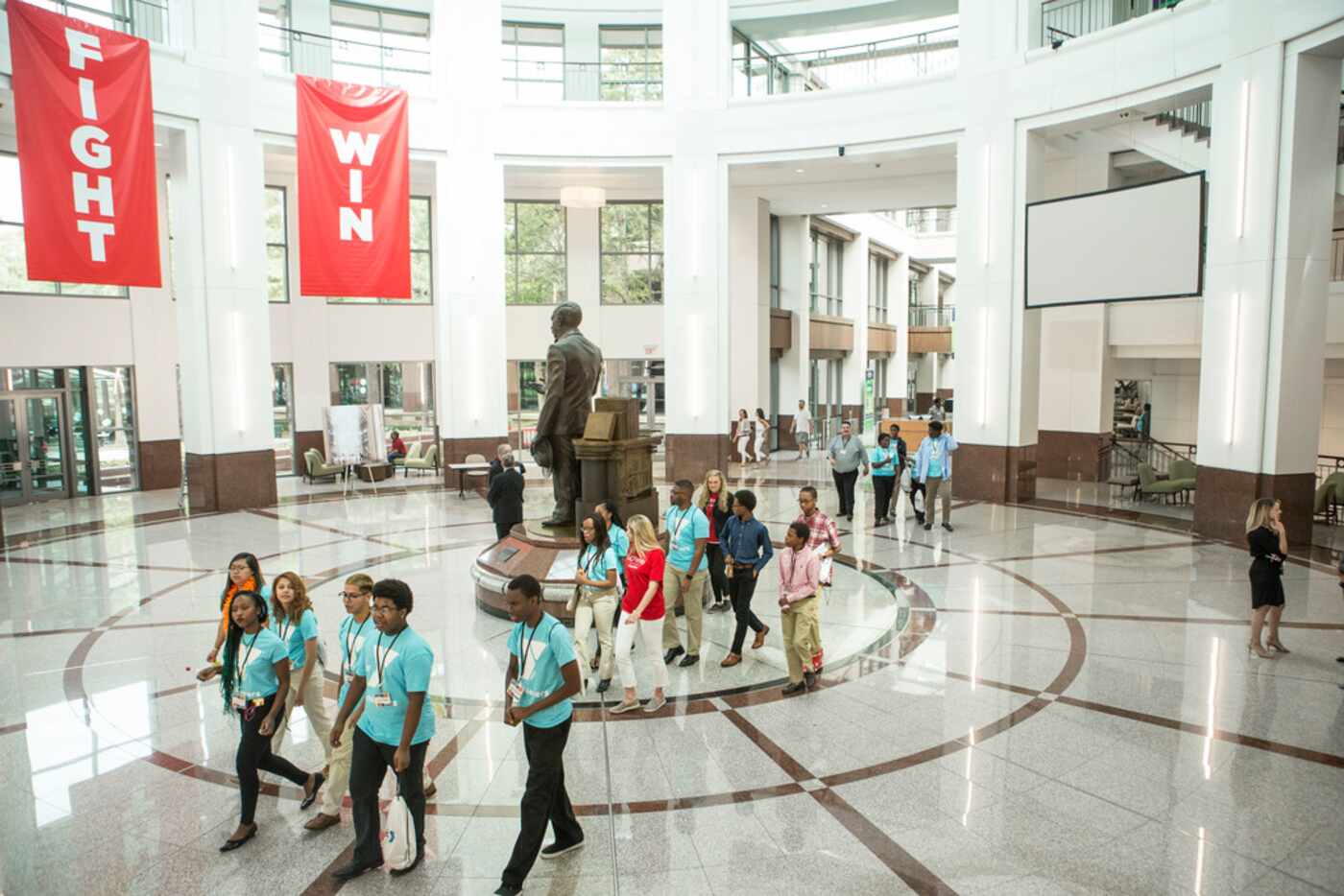 Kids walk to an activity during Camp JCPenney at J. C. Penney Headquarters in Plan on...