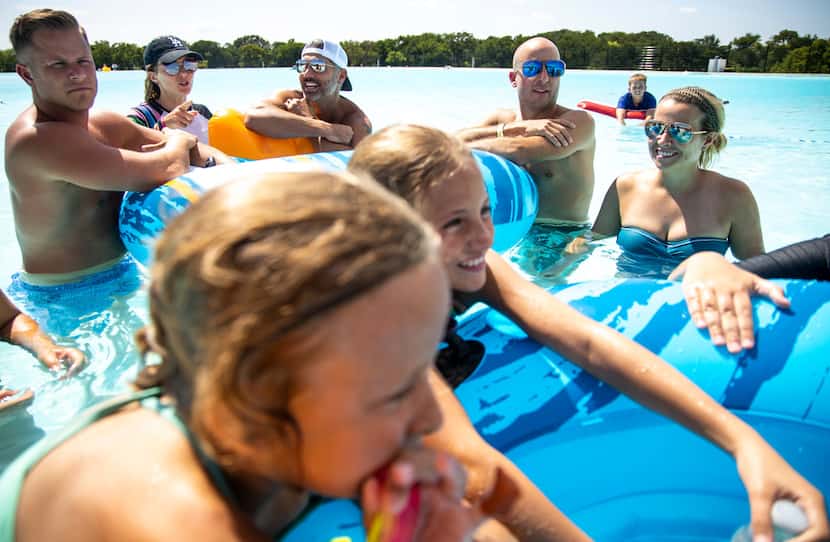Family and friends relax at the Crystal Lagoon at Windsong Ranch on Tuesday as they kick off...