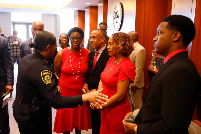 Dallas County Sheriff Marian Brown talks with the Jean family (from left) Allison Jean,...