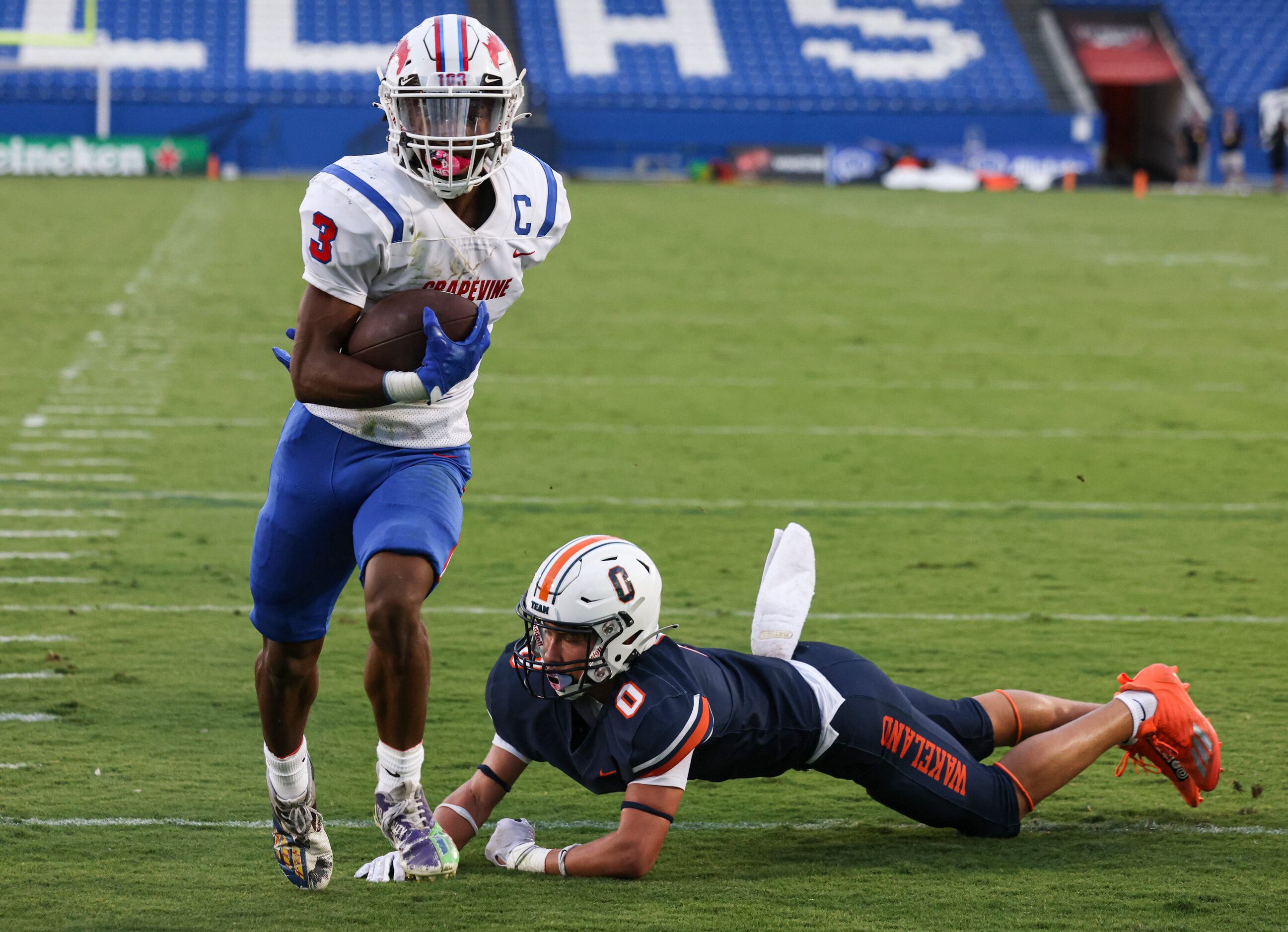 Grapevine High School’s CJ Holmes (3) runs the ball into the end zone to score a touchdown...