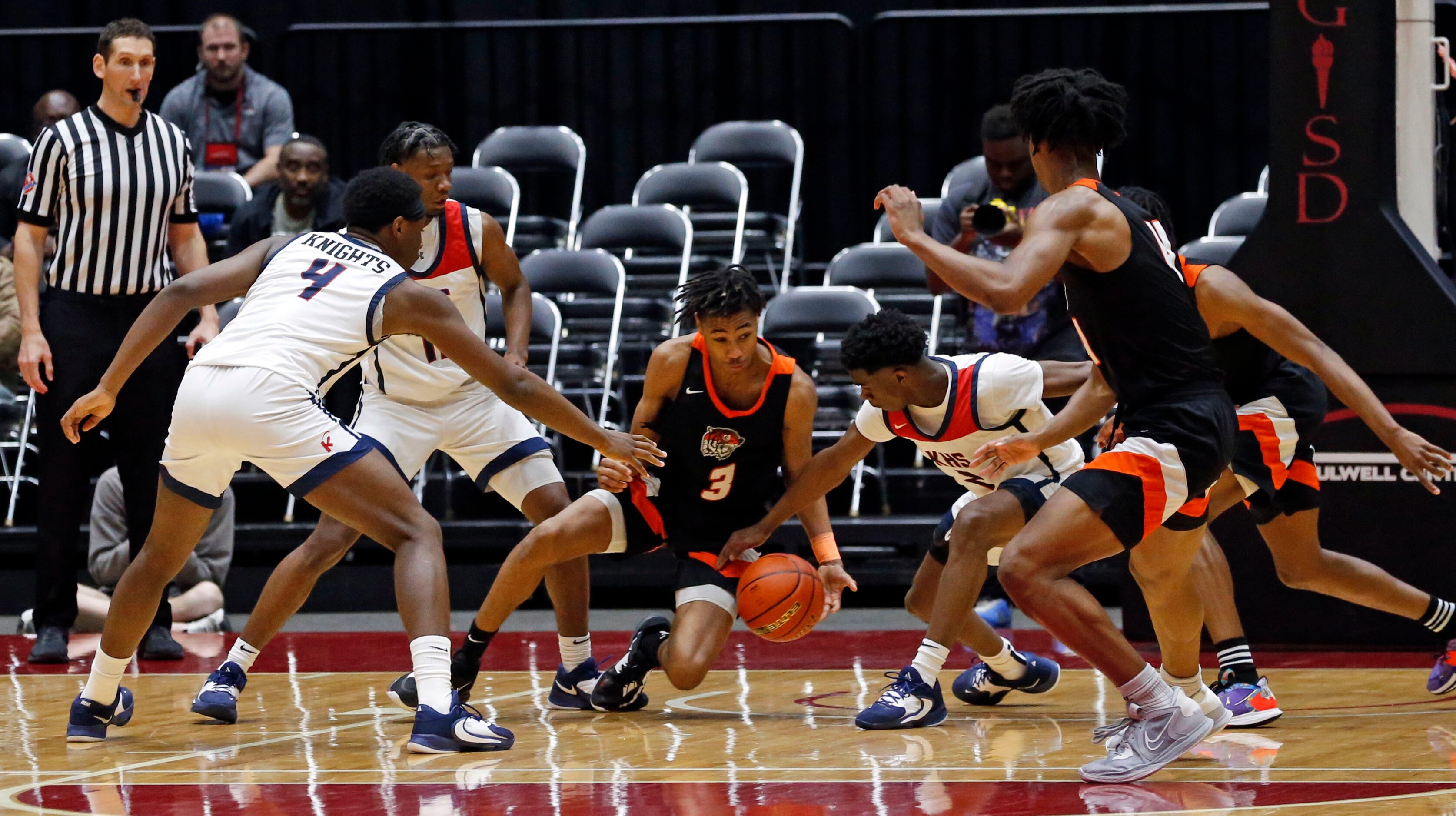 Lancaster High's Joseph Mayberry (3) tries to hold on to the basketball, but is pressured by...