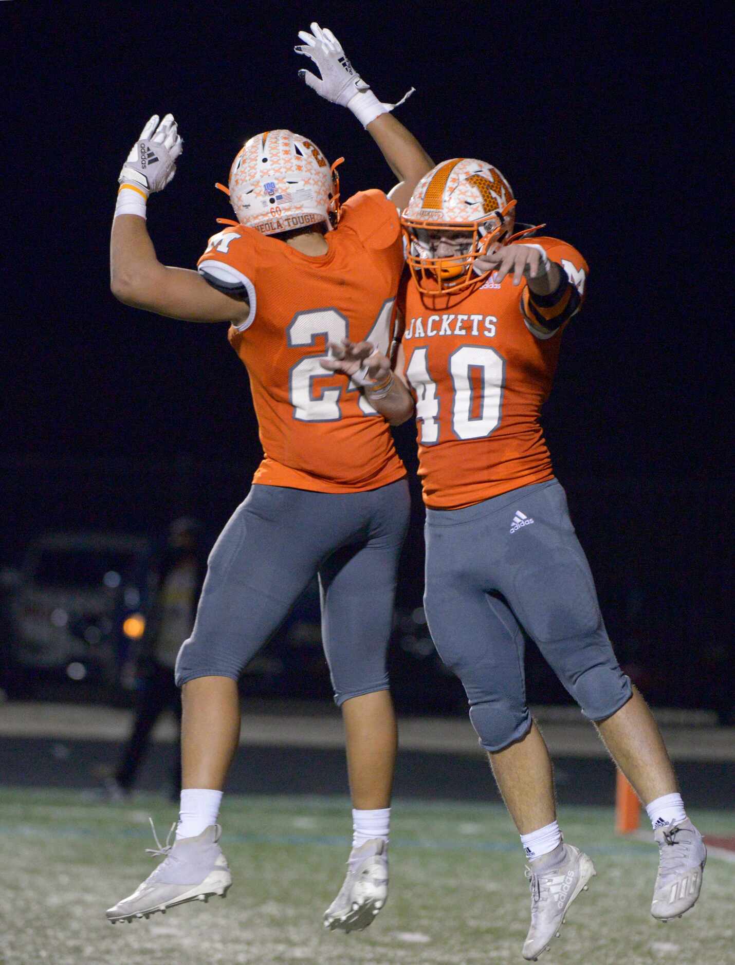 Mineola’s Hunter Wright (40) celebrates his touchdown reception with Kobe Kenrick in the...