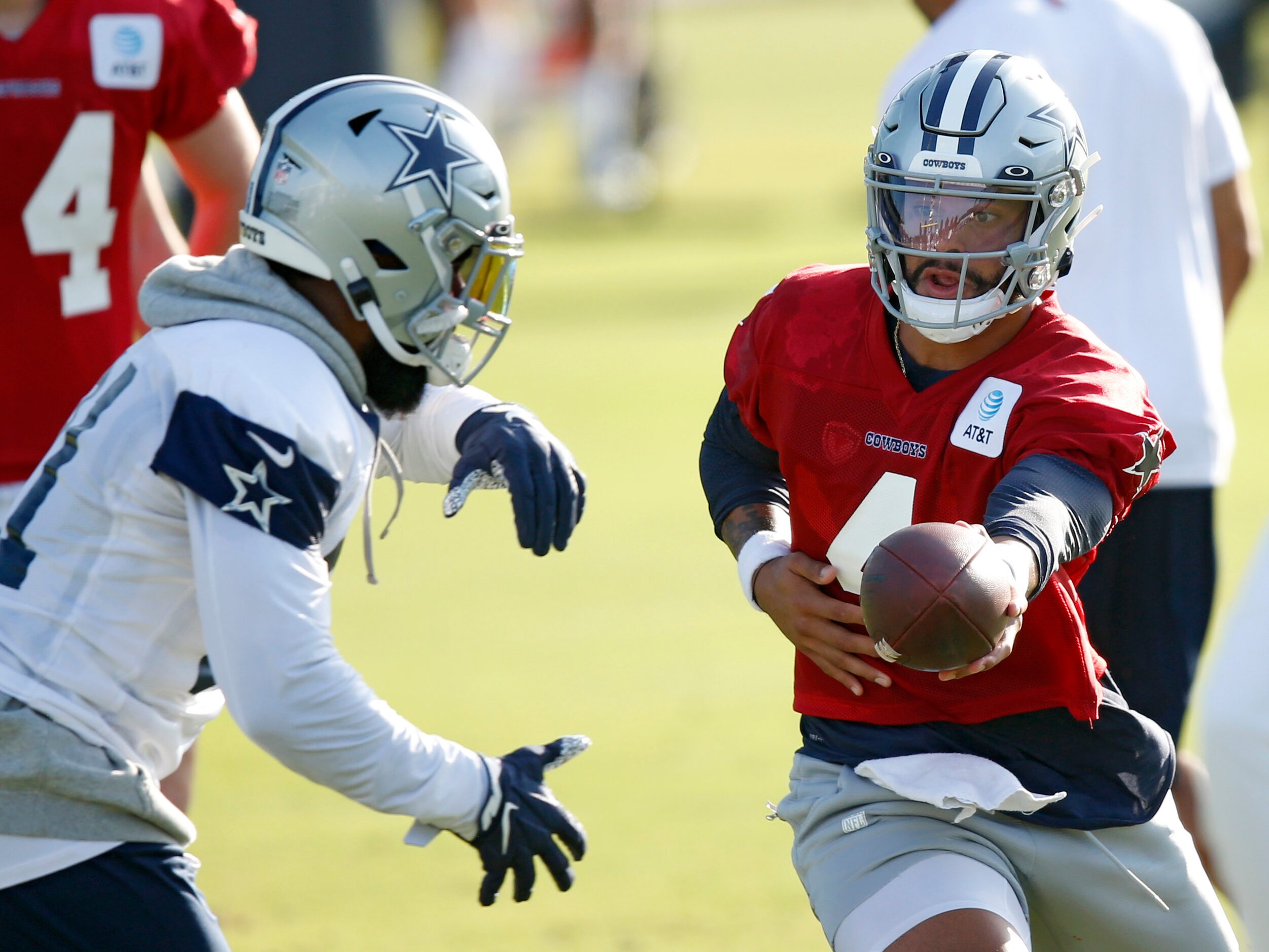 Dallas Cowboys quarterback Dak Prescott (4) hands the ball off to Dallas Cowboys running...