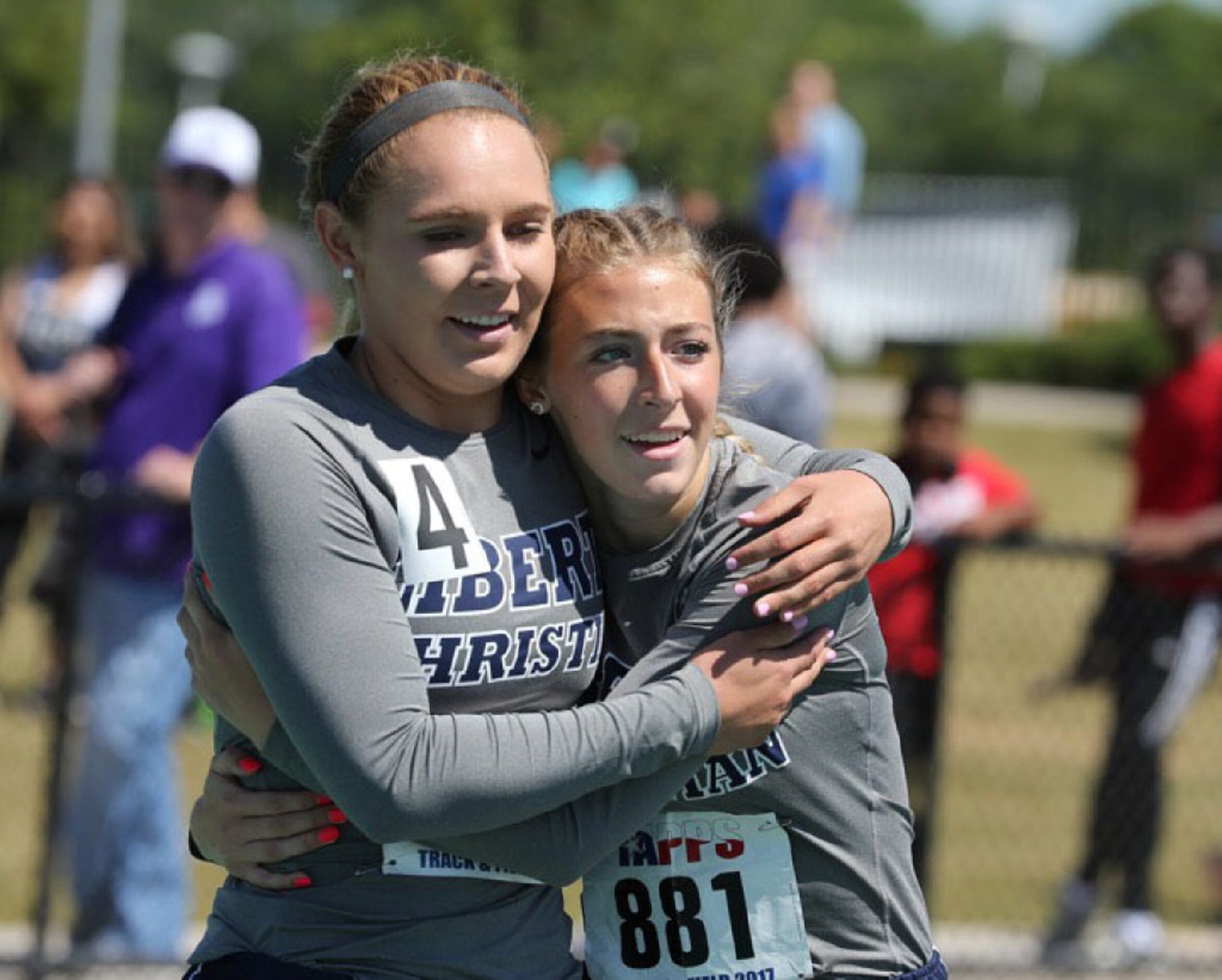 Argyle Liberty Christian Izzy Hopkins, right, gets a hug from teammate Maddi Willet, left,...