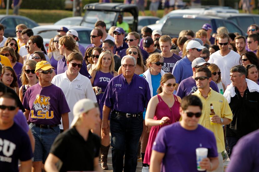 TCU and LSU fans pour across North Collins St. to head to AT&T Stadium for the NCAA college...