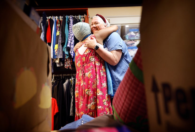 Volunteer Debbie Zeltman (right) receives a tear-filled hug from Colombian migrant Ada...