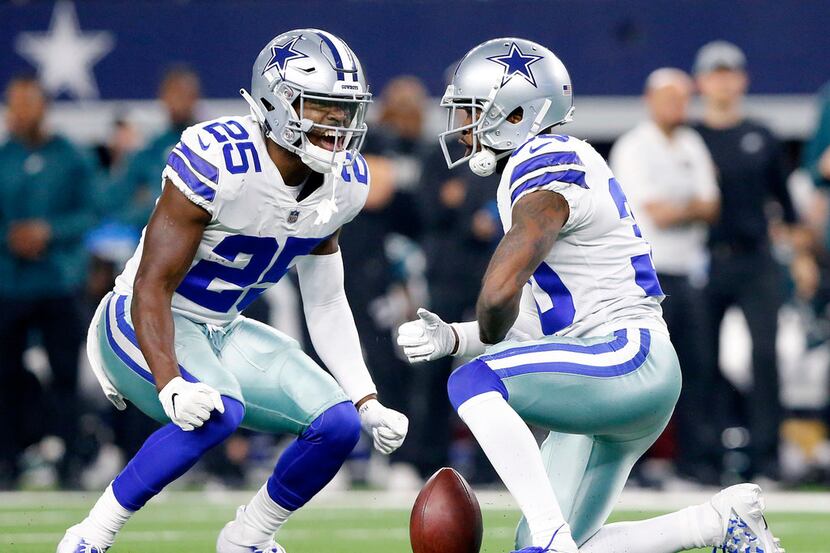 Dallas Cowboys free safety Xavier Woods (25) celebrate cornerback Anthony Brown's (30) pass...