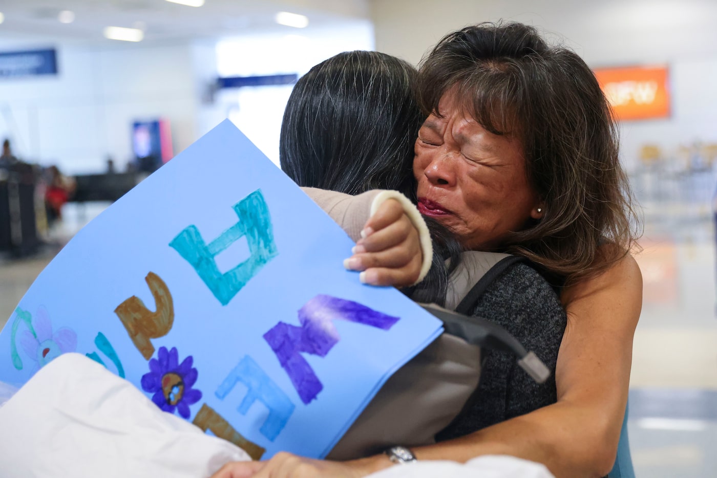 Catherine Harned (right) reunites with her sister Anna Samuelsson, of Sweden, on Wednesday,...